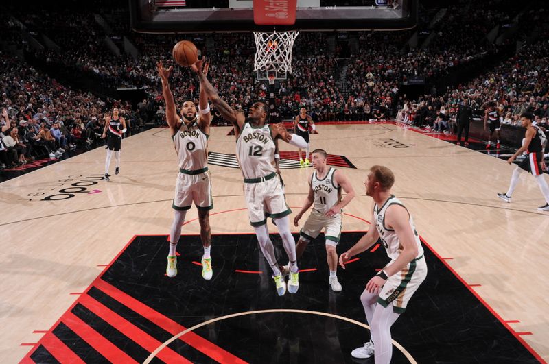 PORTLAND, OR - MARCH 11:  Oshae Brissett #12 of the Boston Celtics rebounds the ball during the game against the Portland Trail Blazers on March 11, 2024 at the Moda Center Arena in Portland, Oregon. NOTE TO USER: User expressly acknowledges and agrees that, by downloading and or using this photograph, user is consenting to the terms and conditions of the Getty Images License Agreement. Mandatory Copyright Notice: Copyright 2024 NBAE (Photo by Cameron Browne/NBAE via Getty Images)