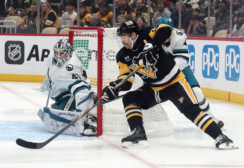 Nov 16, 2024; Pittsburgh, Pennsylvania, USA;  Pittsburgh Penguins right wing Bryan Rust (17) shoots and scores a goal against San Jose Sharks goaltender Vitek Vanecek (41) during the first period at PPG Paints Arena. Mandatory Credit: Charles LeClaire-Imagn Images