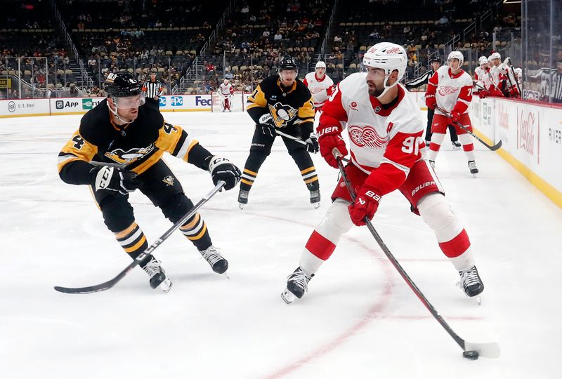 Oct 1, 2024; Pittsburgh, Pennsylvania, USA;  Detroit Red Wings center Joe Veleno (90) moves the puck against Pittsburgh Penguins defenseman Matt Grzelcyk (24) during the second period at PPG Paints Arena. Mandatory Credit: Charles LeClaire-Imagn Images