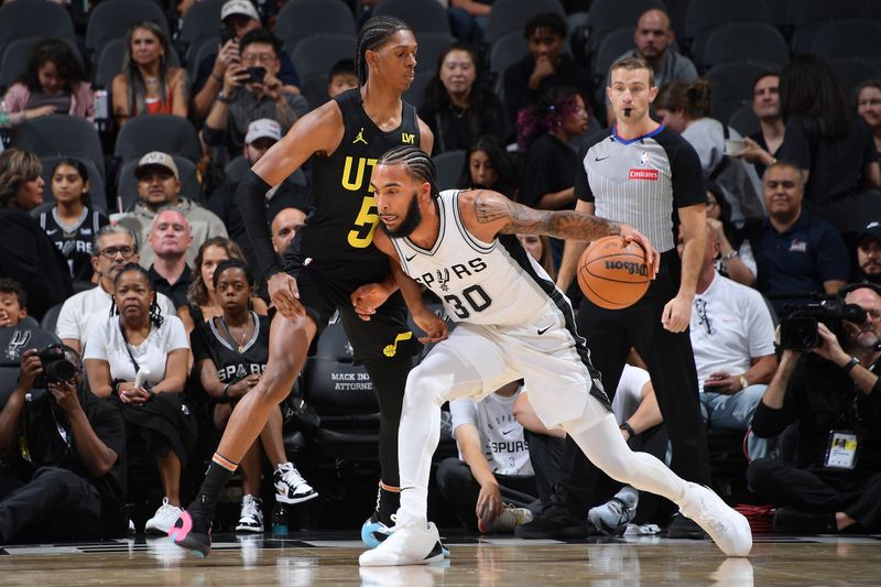 SAN ANTONIO, TX - OCTOBER 12: Julian Champagnie #30 of the San Antonio Spurs dribbles the ball during the game against the Utah Jazz during a NBA preseason game on October 12, 2024 at the Frost Bank Center in San Antonio, Texas. NOTE TO USER: User expressly acknowledges and agrees that, by downloading and or using this photograph, user is consenting to the terms and conditions of the Getty Images License Agreement. Mandatory Copyright Notice: Copyright 2024 NBAE (Photos by Michael Gonzales/NBAE via Getty Images)