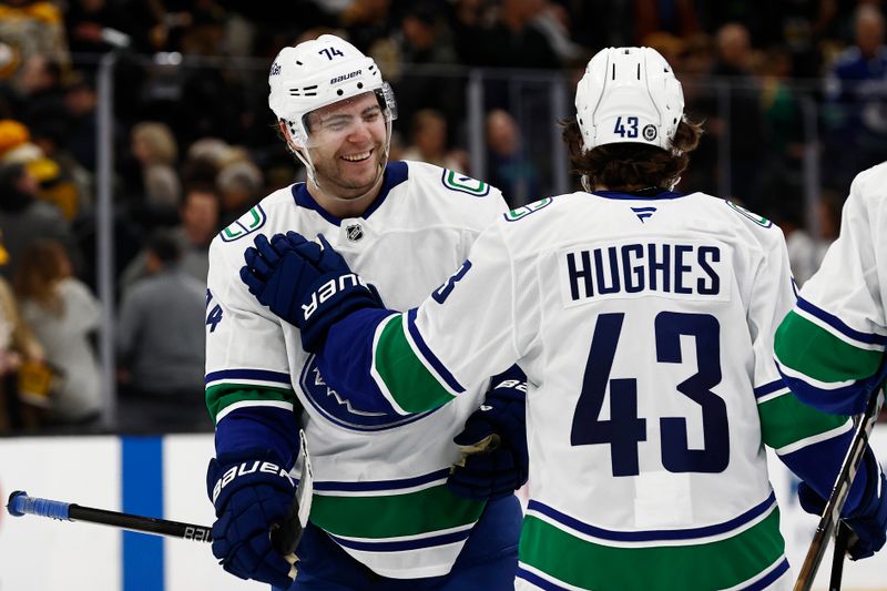 Nov 26, 2024; Boston, Massachusetts, USA; Vancouver Canucks left wing Jake DeBrusk (74) smiles at captain Quinn Hughes (43) after their 2-0 win over the Boston Bruins at TD Garden. Mandatory Credit: Winslow Townson-Imagn Images