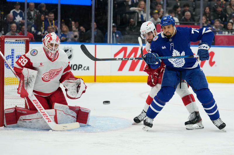 Nov 8, 2024; Toronto, Ontario, CAN; Toronto Maple Leafs forward Ryan Reaves (75) tries to deflect a puck against Detroit Red Wings goaltender Cam Talbot (39) during the third period at Scotiabank Arena. Mandatory Credit: John E. Sokolowski-Imagn Images