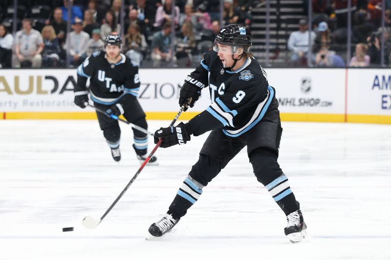 Oct 24, 2024; Salt Lake City, Utah, USA; Utah Hockey Club center Clayton Keller (9) passes the puck against the Colorado Avalanche during the second period at Delta Center. Mandatory Credit: Rob Gray-Imagn Images