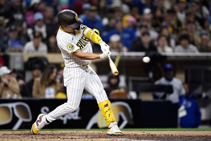Apr 20, 2024; San Diego, California, USA; San Diego Padres shortstop Ha-Seong Kim (7) hits an RBI single against the Toronto Blue Jays during the eighth inning at Petco Park. Mandatory Credit: Orlando Ramirez-USA TODAY Sports