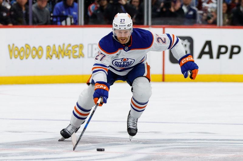 Jan 16, 2025; Denver, Colorado, USA; Edmonton Oilers defenseman Brett Kulak (27) controls the puck in the first period against the Colorado Avalanche at Ball Arena. Mandatory Credit: Isaiah J. Downing-Imagn Images