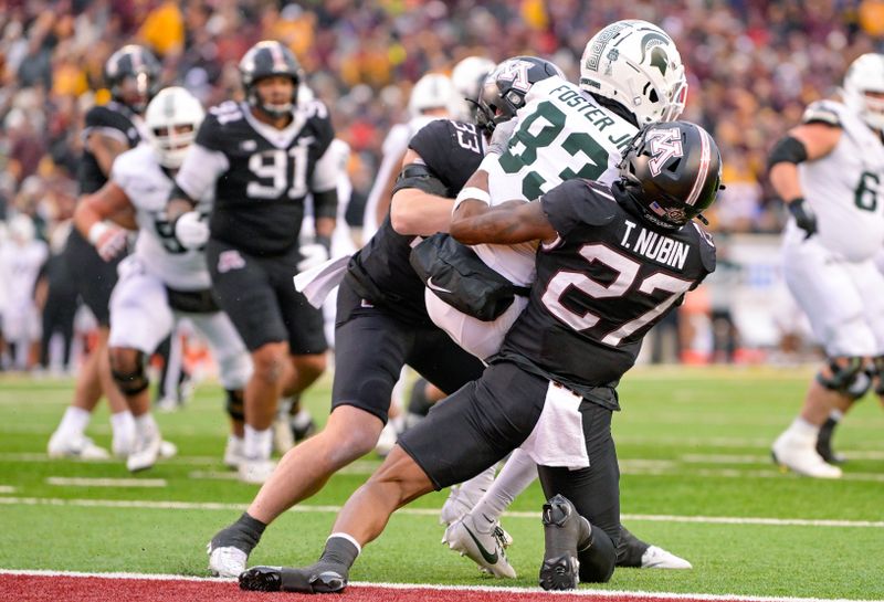 Oct 28, 2023; Minneapolis, Minnesota, USA;  Minnesota Golden Gophers defensive back Tyler Nubin (27) and linebacker Ryan Selig (33) prevent Michigan State Spartans wide receiver Montorie Foster Jr. (83) from converting on a two-point try during the fourth quarter at Huntington Bank Stadium. Mandatory Credit: Nick Wosika-USA TODAY Sports