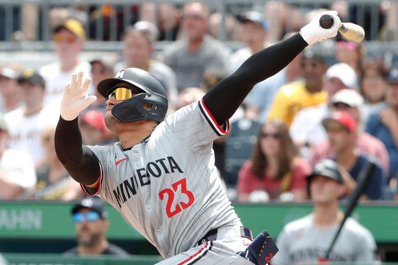 Jun 9, 2024; Pittsburgh, Pennsylvania, USA; Minnesota Twins pinch hitter Royce Lewis (23) drives in a run with a sacrifice fly against the Pittsburgh Pirates during the sixth inning at PNC Park. Mandatory Credit: Charles LeClaire-USA TODAY Sports