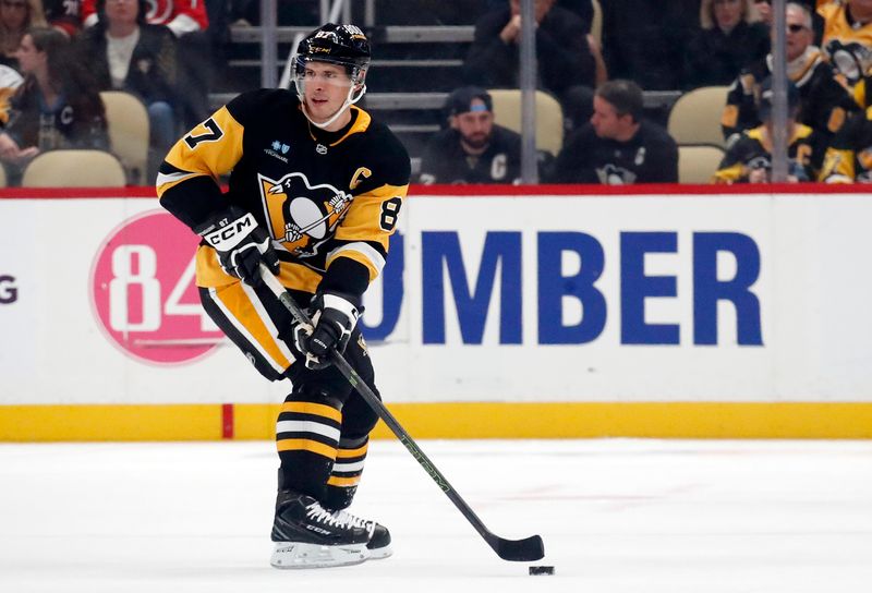 Oct 18, 2024; Pittsburgh, Pennsylvania, USA;  Pittsburgh Penguins center Sidney Crosby (87) skates with the puck against the Carolina Hurricanes during the first period at PPG Paints Arena. Mandatory Credit: Charles LeClaire-Imagn Images