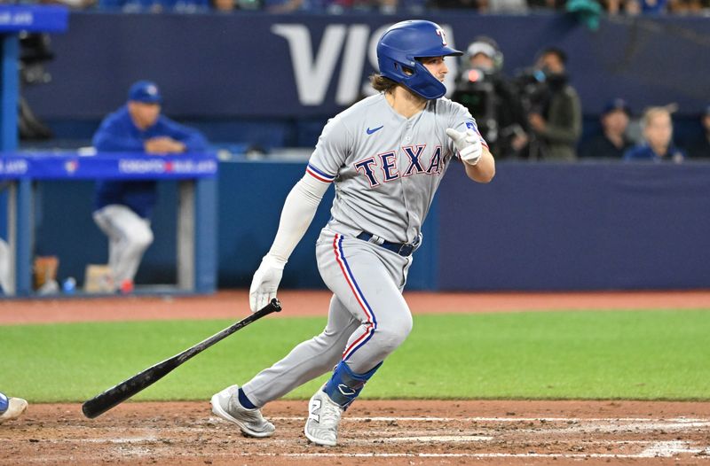 Sep 12, 2023; Toronto, Ontario, CAN;  Texas Rangers third baseman Josh Smith (47) hits an RBI double against the Toronto Blue Jays in the seventh inning at Rogers Centre. Mandatory Credit: Dan Hamilton-USA TODAY Sports