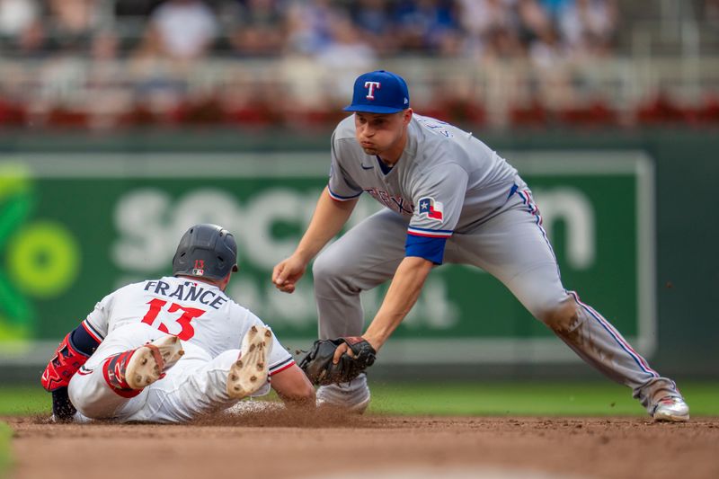 Jun 10, 2025; Minneapolis, Minnesota, USA; Texas Rangers shortstop Corey Seager (5) tags out Minnesota Twins first baseman Ty France (13) sliding into second base trying to extend a single into a double in the fourth inning at Target Field. Mandatory Credit: Jesse Johnson-Imagn Images