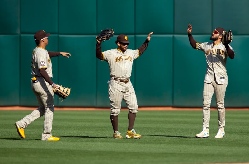 Sep 16, 2023; Oakland, California, USA; San Diego Padres outfielders Juan Soto (from left), Trent Grisham and Fernando Tatis Jr. celebrate their victory over the Oakland Athletics at Oakland-Alameda County Coliseum. Mandatory Credit: D. Ross Cameron-USA TODAY Sports
