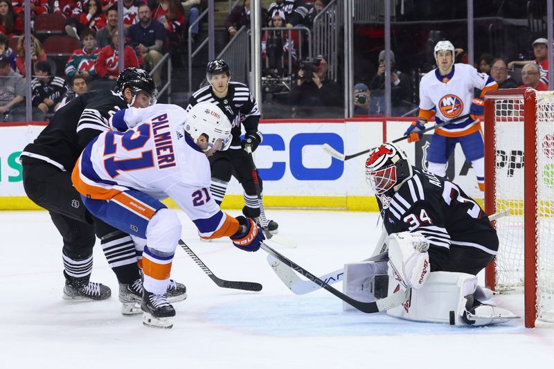 Apr 15, 2024; Newark, New Jersey, USA; New Jersey Devils goaltender Jake Allen (34) makes a save on New York Islanders center Kyle Palmieri (21) during the first period at Prudential Center. Mandatory Credit: Ed Mulholland-USA TODAY Sports