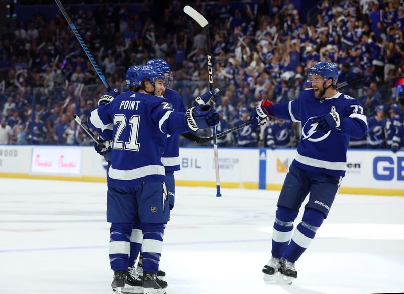 Oct 10, 2023; Tampa, Florida, USA; Tampa Bay Lightning right wing Nikita Kucherov (86) is congratulated by center Brayden Point (21) and defenseman Victor Hedman (77) after he scored a goal against the Nashville Predators during the first period at Amalie Arena. Mandatory Credit: Kim Klement Neitzel-USA TODAY Sports