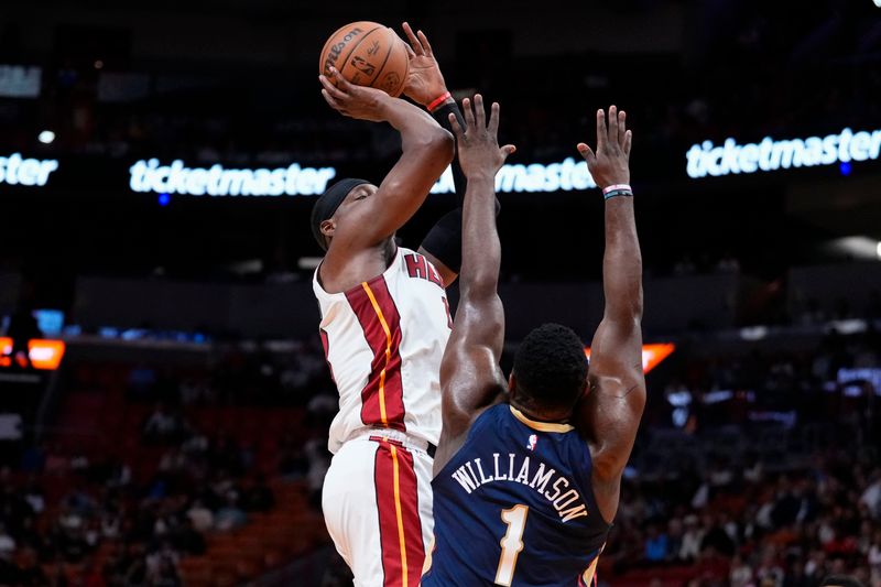 MIAMI, FLORIDA - MARCH 22: Bam Adebayo #13 of the Miami Heat goes up for a shot against Zion Williamson #1 of the New Orleans Pelicans during the first quarter at Kaseya Center on March 22, 2024 in Miami, Florida. NOTE TO USER: User expressly acknowledges and agrees that, by downloading and or using this photograph, User is consenting to the terms and conditions of the Getty Images License Agreement. (Photo by Rich Storry/Getty Images)