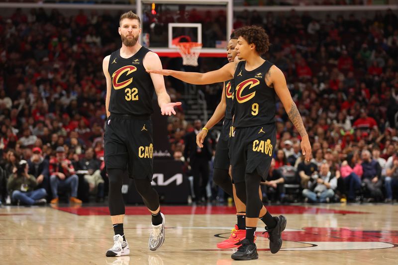 CHICAGO, ILLINOIS - DECEMBER 23: Dean Wade #32 of the Cleveland Cavaliers high fives Craig Porter #9 against the Chicago Bulls during the first half at the United Center on December 23, 2023 in Chicago, Illinois. NOTE TO USER: User expressly acknowledges and agrees that, by downloading and or using this photograph, User is consenting to the terms and conditions of the Getty Images License Agreement.  (Photo by Michael Reaves/Getty Images)