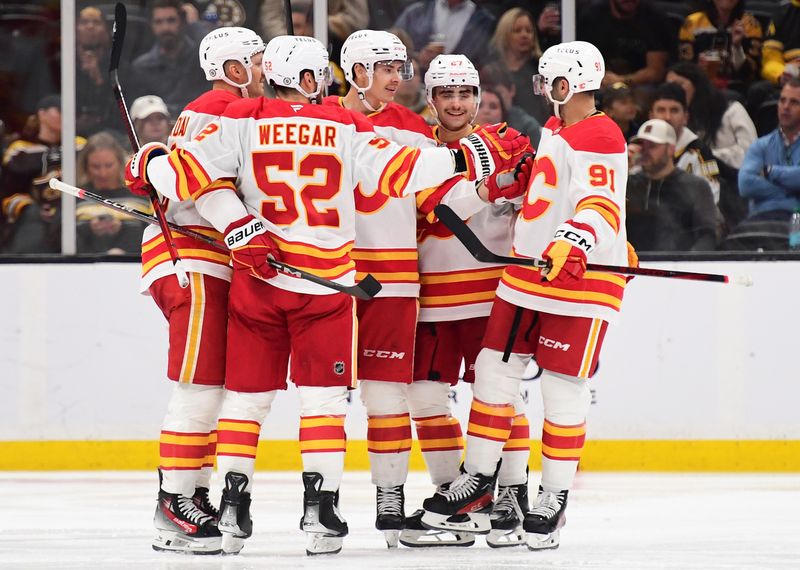 Nov 7, 2024; Boston, Massachusetts, USA;  Calgary Flames center Yegor Sharangovich (17) is congratulated by teammates after scoring a goal during the third period against the Boston Bruins at TD Garden. Mandatory Credit: Bob DeChiara-Imagn Images