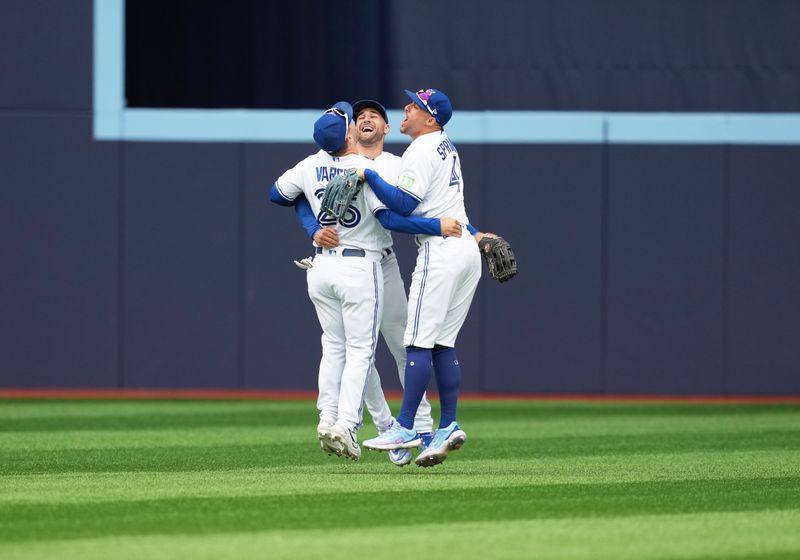 Sep 9, 2023; Toronto, Ontario, CAN; Toronto Blue Jays left fielder Daulton Varsho (25), center fielder Kevin Kiermaier (39), and right fielder George Springer (4) celebrate the win against the Kansas City Royals at the end of the ninth inning at Rogers Centre. Mandatory Credit: Nick Turchiaro-USA TODAY Sports