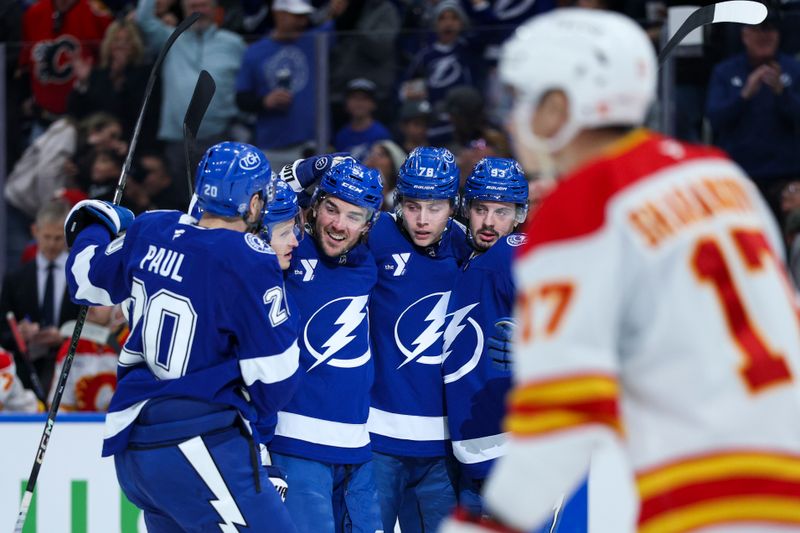 Nov 26, 2025; Tampa, Florida, USA; Tampa Bay Lightning left wing Nick Paul (20) defenseman Charle-Edouard D'Astous (51) defenseman Emil Lilleberg (78) and center Gage Goncalves (93) react after a goal against the Calgary Flames in the first period at Benchmark International Arena. Mandatory Credit: Nathan Ray Seebeck-Imagn Images