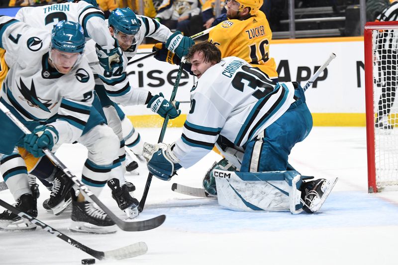 Mar 19, 2024; Nashville, Tennessee, USA; San Jose Sharks goaltender Magnus Chrona (30) loses his helmet on a play during the first period against the Nashville Predators at Bridgestone Arena. Mandatory Credit: Christopher Hanewinckel-USA TODAY Sports