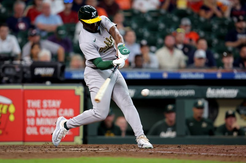 Sep 12, 2024; Houston, Texas, USA; Oakland Athletics left fielder Daz Cameron (28) hits an RBI single to right field against the Houston Astros during the seventh inning at Minute Maid Park. Mandatory Credit: Erik Williams-Imagn Images