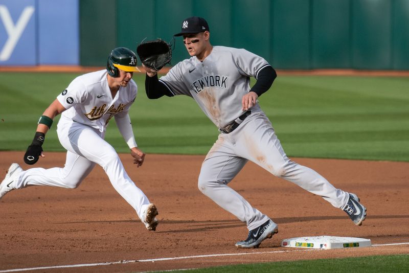 Jun 27, 2023; Oakland, California, USA; New York Yankees first baseman Anthony Rizzo (48) covers first base in an attempt to tag out Oakland Athletics first baseman Ryan Noda (49) during the first inning at Oakland-Alameda County Coliseum. Mandatory Credit: Ed Szczepanski-USA TODAY Sports