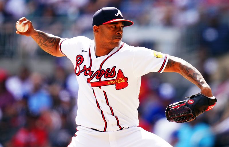 Sep 10, 2023; Cumberland, Georgia, USA; Atlanta Braves relief pitcher Raisel Iglesias (26) pitching against the Pittsburgh Pirates during the ninth inning at Truist Park. Mandatory Credit: John David Mercer-USA TODAY Sports