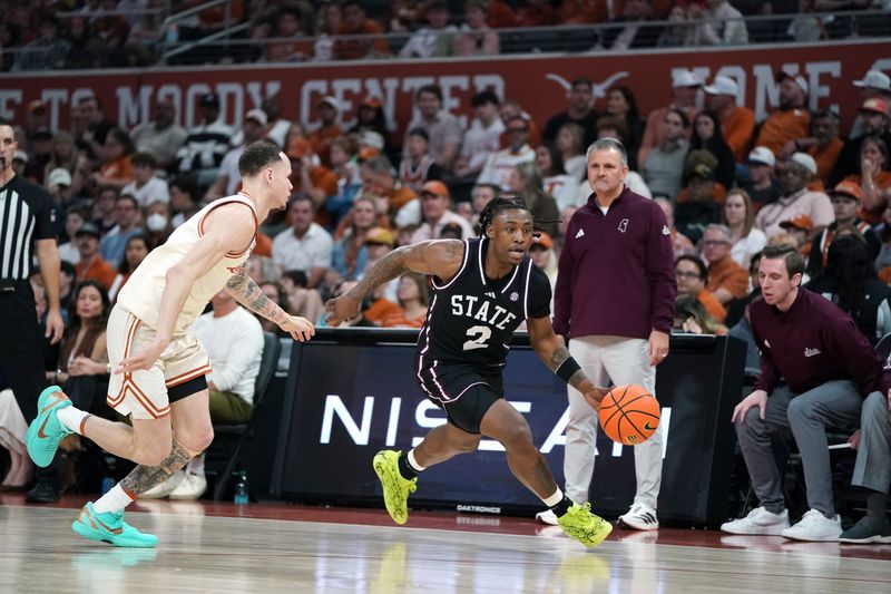 Jan 3, 2026; Austin, Texas, USA; Mississippi State Bulldogs guard Ja’borri Mcghee (2) drives to the basket against Texas Longhorns guard Chendall Weaver (2) during the second half at Moody Center. Mandatory Credit: Dustin Safranek-Imagn Images