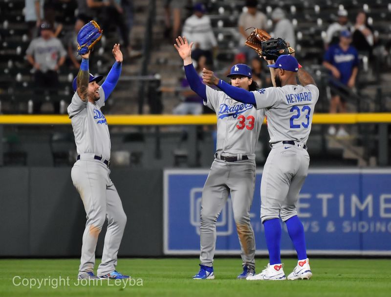 Sep 27, 2023; Denver, Colorado, USA; Los Angeles Dodgers left fielder David Peralta (6) Los Angeles Dodgers center fielder James Outman (33) and Los Angeles Dodgers right fielder Jason Heyward (23) celebrate in the outfield the win over the Colorado Rockies at Coors Field. Mandatory Credit: John Leyba-USA TODAY Sports