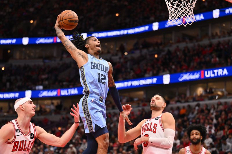 CHICAGO, ILLINOIS - APRIL 02:  Ja Morant #12 of the Memphis Grizzlies soars in to dunk the ball as Alex Caruso #6 of the Chicago Bulls and Nikola Vucevic #9 defend in the second half on April 02, 2023 at United Center in Chicago, Illinois. Chicago defeated Memphis 128-107.   NOTE TO USER: User expressly acknowledges and agrees that, by downloading and or using this photograph, User is consenting to the terms and conditions of the Getty Images License Agreement.  (Photo by Jamie Sabau/Getty Images)