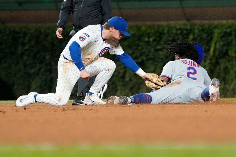Sep 23, 2025; Chicago, Illinois, USA; New York Mets pinch-runner Luisangel Acuna (2) steals second as Chicago Cubs second baseman Nico Hoerner (2) can’t handle a throw during the eighth inning at Wrigley Field. Mandatory Credit: David Banks-Imagn Images