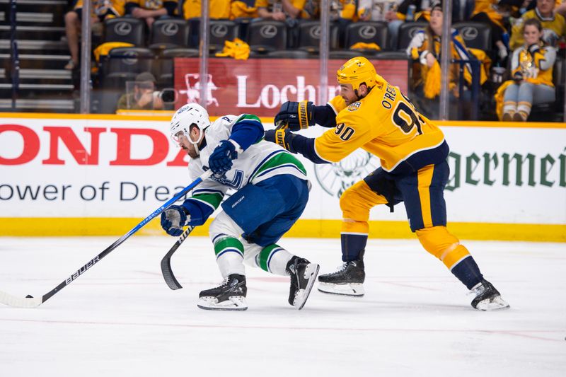 Apr 26, 2024; Nashville, Tennessee, USA; Nashville Predators center Ryan O'Reilly (90) fights with Vancouver Canucks right wing Conor Garland (8) for the puck during the second period in game three of the first round of the 2024 Stanley Cup Playoffs at Bridgestone Arena. Mandatory Credit: Steve Roberts-USA TODAY Sports