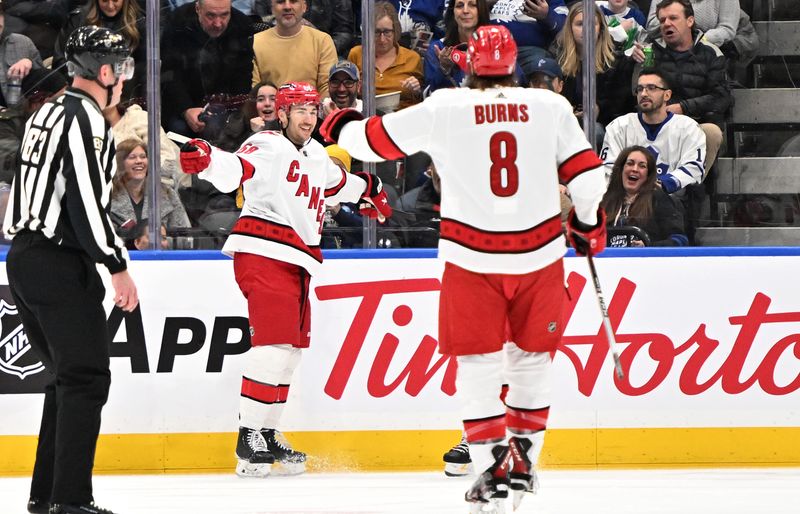 Dec 30, 2023; Toronto, Ontario, CAN; Carolina Hurricanes forward Michael Bunting (58) celebrates after scoring a goal against the Toronto Maple Leafs in the first period at Scotiabank Arena. Mandatory Credit: Dan Hamilton-USA TODAY Sports