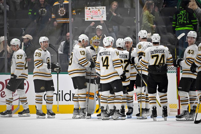 Nov 6, 2023; Dallas, Texas, USA; The Boston Bruins celebrate on the ice after the Bruins victory over the Dallas Stars at the American Airlines Center. Mandatory Credit: Jerome Miron-USA TODAY Sports