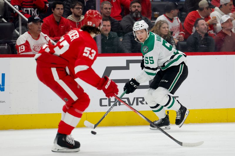 Jan 23, 2024; Detroit, Michigan, USA;  Dallas Stars defenseman Thomas Harley (55) skates with the puck defended by Detroit Red Wings defenseman Moritz Seider (53) in the first period at Little Caesars Arena. Mandatory Credit: Rick Osentoski-USA TODAY Sports