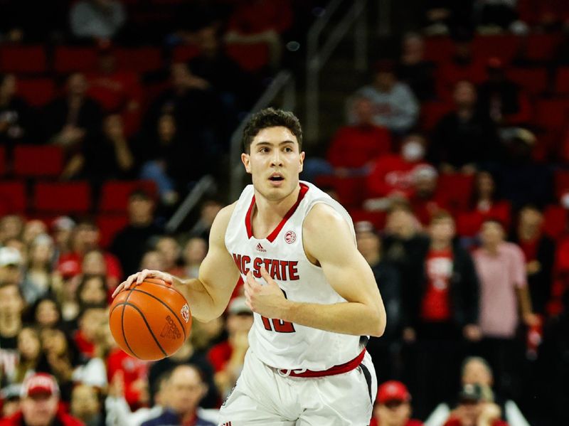 Jan 30, 2024; Raleigh, North Carolina, USA; North Carolina State Wolfpack guard Michael O'Connell (12) dribbles with the ball during the first half against Miami (Fl) Hurricanes at PNC Arena. Mandatory Credit: Jaylynn Nash-USA TODAY Sports