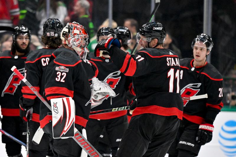 Jan 25, 2023; Dallas, Texas, USA; Carolina Hurricanes goaltender Antti Raanta (32) and center Jordan Staal (11) celebrate the win over the Dallas Stars during the overtime period at the American Airlines Center. Mandatory Credit: Jerome Miron-USA TODAY Sports