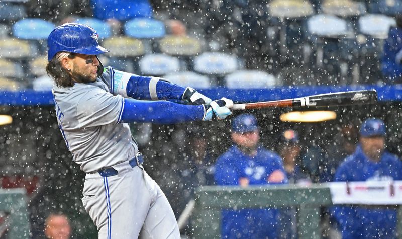 Apr 25, 2024; Kansas City, Missouri, USA;  Toronto Blue Jays shortstop Bo Bichette (11) hits the ball to right field in the fifth inning against the Kansas City Royals at Kauffman Stadium. Mandatory Credit: Peter Aiken-USA TODAY Sports