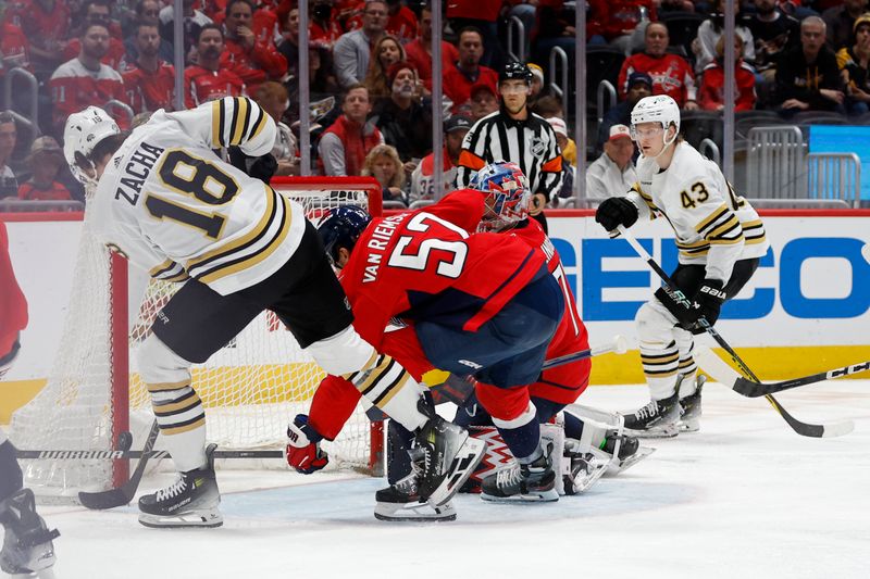 Apr 15, 2024; Washington, District of Columbia, USA; Boston Bruins center Pavel Zacha (18) attempts a shot on Washington Capitals goaltender Charlie Lindgren (79) as Capitals defenseman Dylan McIlrath (52) defends in the second period at Capital One Arena. Mandatory Credit: Geoff Burke-USA TODAY Sports