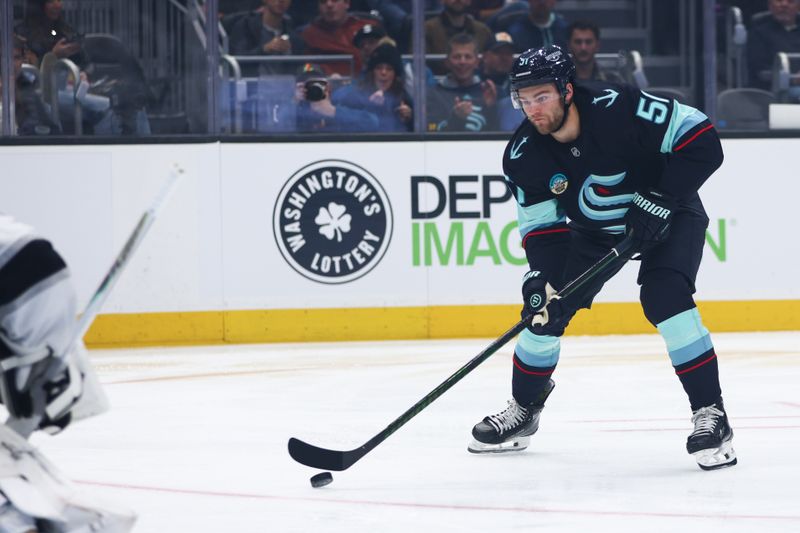 Dec 10, 2025; Seattle, Washington, USA;  Seattle Kraken center Shane Wright (51) takes a shot at goal in the first period against the Los Angeles Kings at Climate Pledge Arena. Mandatory Credit: Kevin Ng-Imagn Images