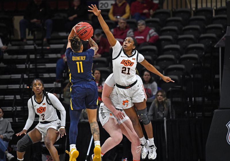 Mar 10, 2023; Kansas City, MO, USA;  Oklahoma State Cowgirls guard Terryn Milton (21) defends West Virginia Mountaineers guard JJ Quinerly (11) during the first half at Municipal Auditorium. Mandatory Credit: Peter Aiken-USA TODAY Sports