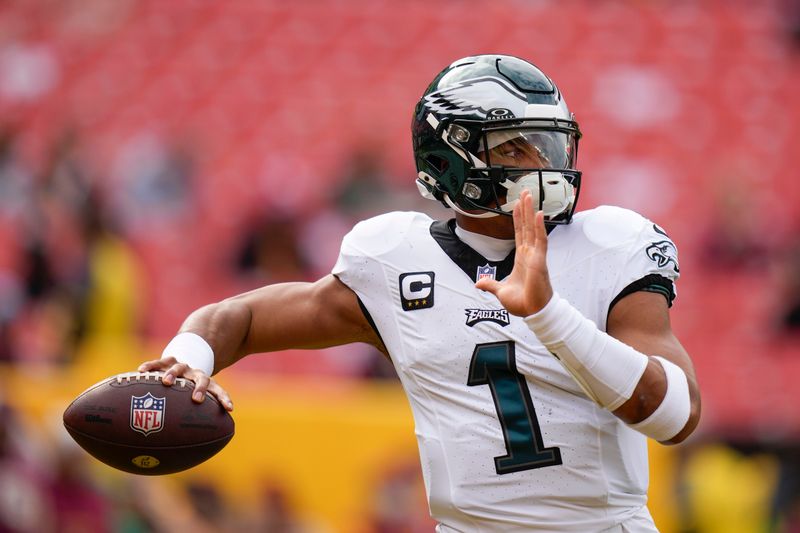 Philadelphia Eagles quarterback Jalen Hurts (1) warming up before the start of an NFL football game against the Washington Commanders, Sunday, Oct. 29, 2023, in Landover, Md. (AP Photo/Alex Brandon)