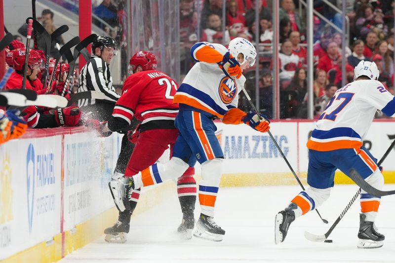 Oct 30, 2025; Raleigh, North Carolina, USA;  <p><br/></p>10 side steps a check by Carolina Hurricanes defenseman Alexander Nikishin (21) during the first period at Lenovo Center. Mandatory Credit: James Guillory-Imagn Images