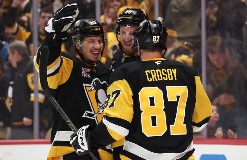 Jan 31, 2026; Pittsburgh, Pennsylvania, USA;  Pittsburgh Penguins right wing Rickard Rakell (left) celebrates his goal with right wing Anthony Mantha (39) and center Sidney Crosby (87) against the New York Rangers during the third period at PPG Paints Arena. Mandatory Credit: Charles LeClaire-Imagn Images