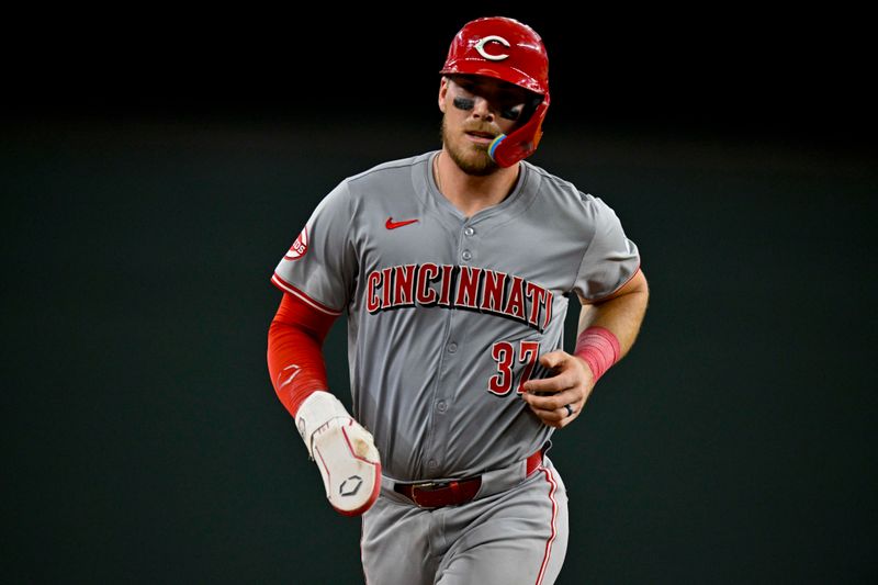 Apr 27, 2024; Arlington, Texas, USA; Cincinnati Reds catcher Tyler Stephenson (37) scores on a home run hit by second baseman Jonathan India (6) against the Texas Rangers during the seventh inning at Globe Life Field. Mandatory Credit: Jerome Miron-USA TODAY Sports