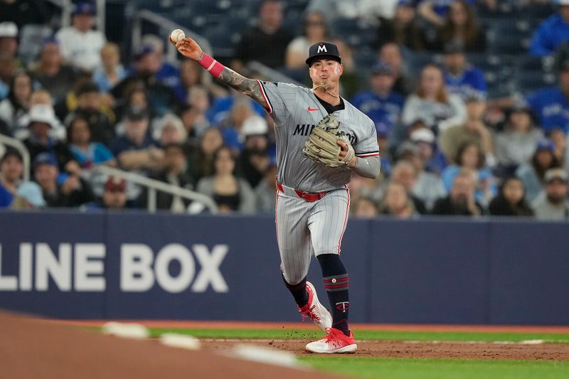 May 10, 2024; Toronto, Ontario, CAN; Minnesota Twins third baseman Jose Miranda (64) throws out Toronto Blue Jays catcher Danny Jansen (not pictured) at first base during the second inning at Rogers Centre. Mandatory Credit: John E. Sokolowski-USA TODAY Sports