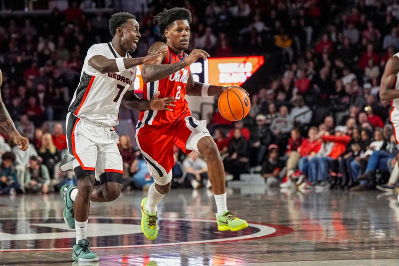 Jan 14, 2026; Athens, Georgia, USA; Mississippi Rebels guard AJ Storr (2) dribbles past Georgia Bulldogs guard Justin Bailey (7) during the first half at Stegeman Coliseum. Mandatory Credit: Dale Zanine-Imagn Images
