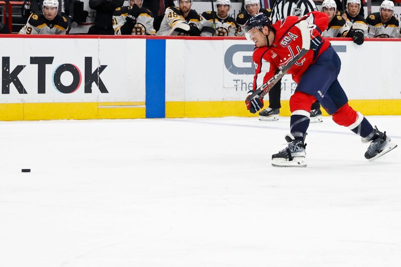 Oct 5, 2024; Washington, District of Columbia, USA; Washington Capitals defenseman John Carlson (74) breaks a stick while taking a slap shot against the Boston Bruins in the third period at Capital One Arena. Mandatory Credit: Geoff Burke-Imagn Images