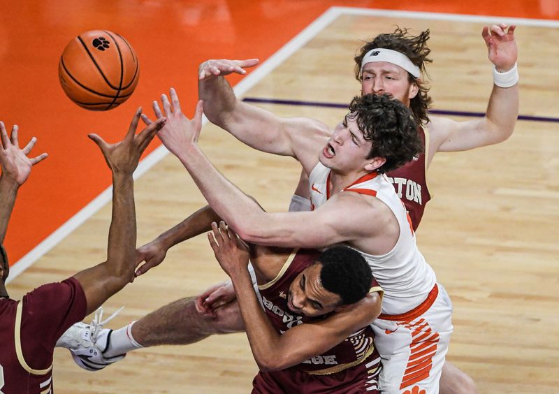 Jan 13, 2024; Clemson, South Carolina, USA; Clemson Tigers forward PJ Hall (24) reaches for a rebound against Boston College Eagles guard Mason Madsen (45) during the first half at Littlejohn Coliseum. Mandatory Credit: Ken Ruinard-USA TODAY Sports