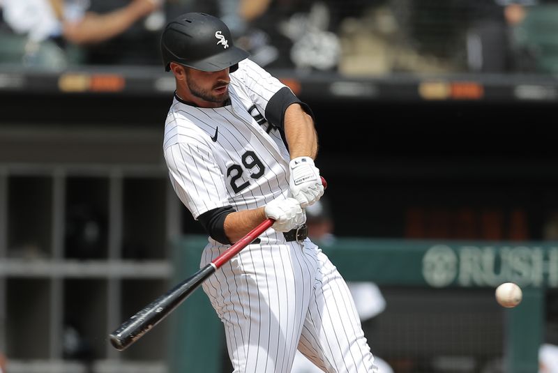 Apr 17, 2024; Chicago, Illinois, USA; Chicago White Sox shortstop Paul DeJong (29) hits a two run home run during game one of a double header against the Kansas City Royals at Guaranteed Rate Field. Mandatory Credit: Melissa Tamez-USA TODAY Sports