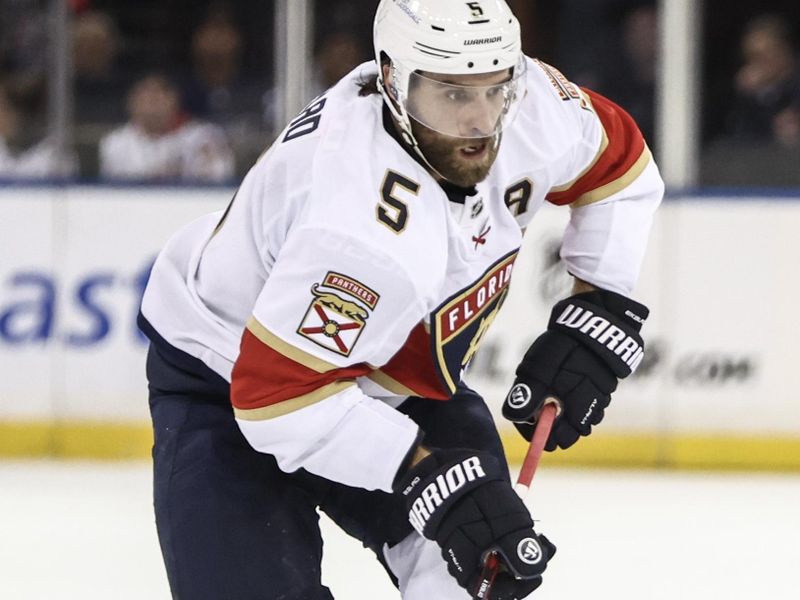 Oct 24, 2024; New York, New York, USA;  Florida Panthers defenseman Aaron Ekblad (5) controls the puck in the first period against the New York Rangers at Madison Square Garden. Mandatory Credit: Wendell Cruz-Imagn Images